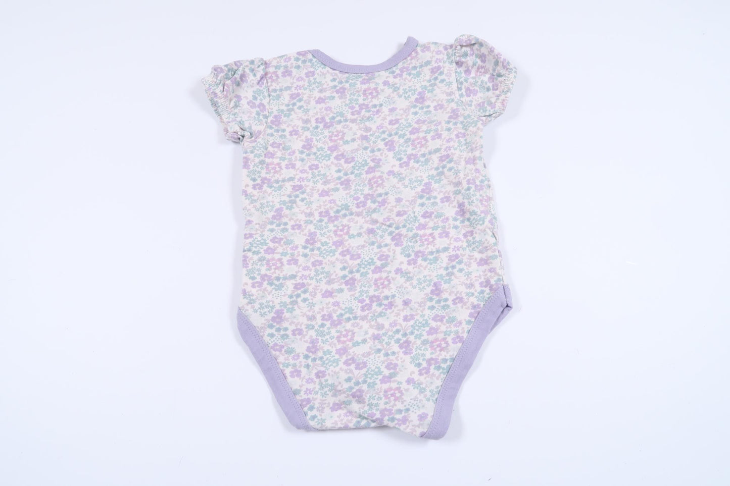 Blommig body från Mini Mow i storlek 62/68