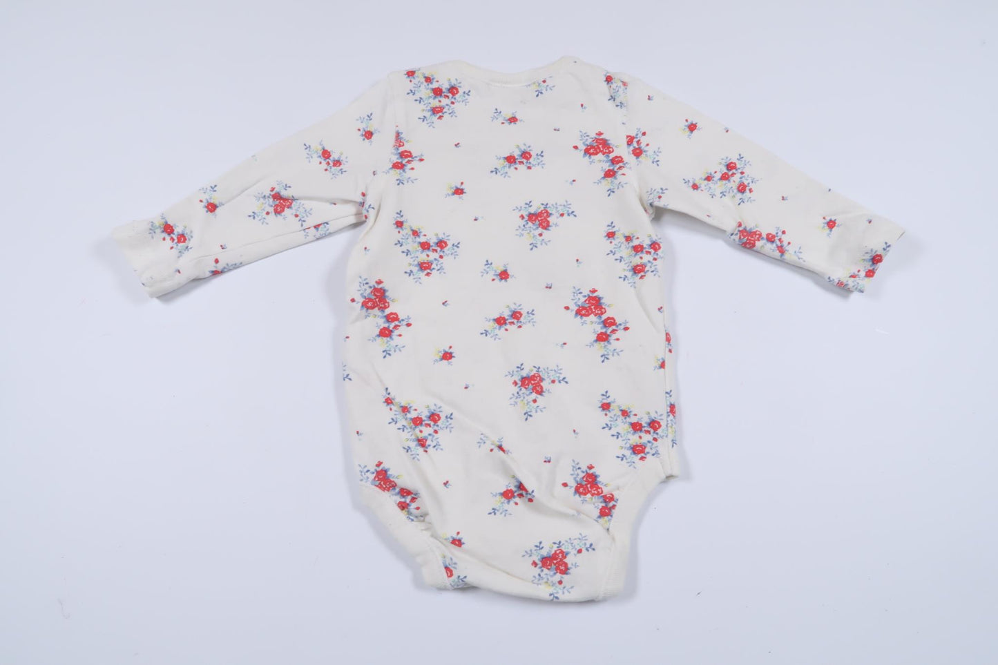 Långärmad body med blommor från Lindex i storlek 62