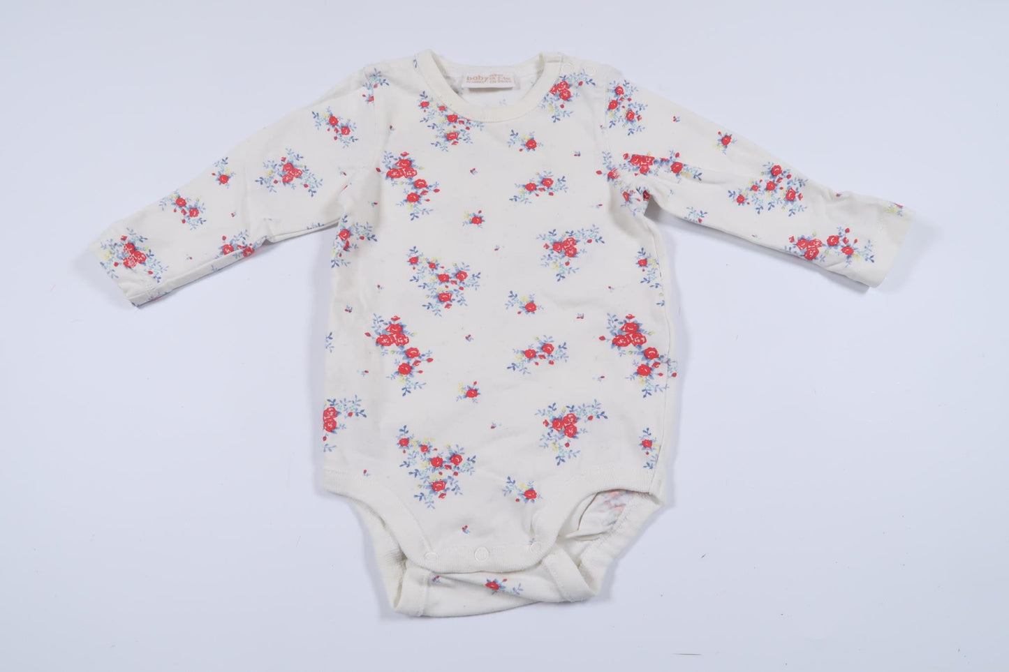 Långärmad body med blommor från Lindex i storlek 62