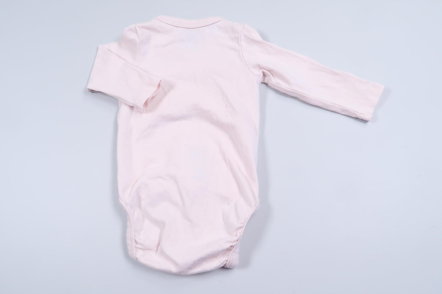 Rosa långärmad omlottbody "Baby Sister" från H&M i storlek 56