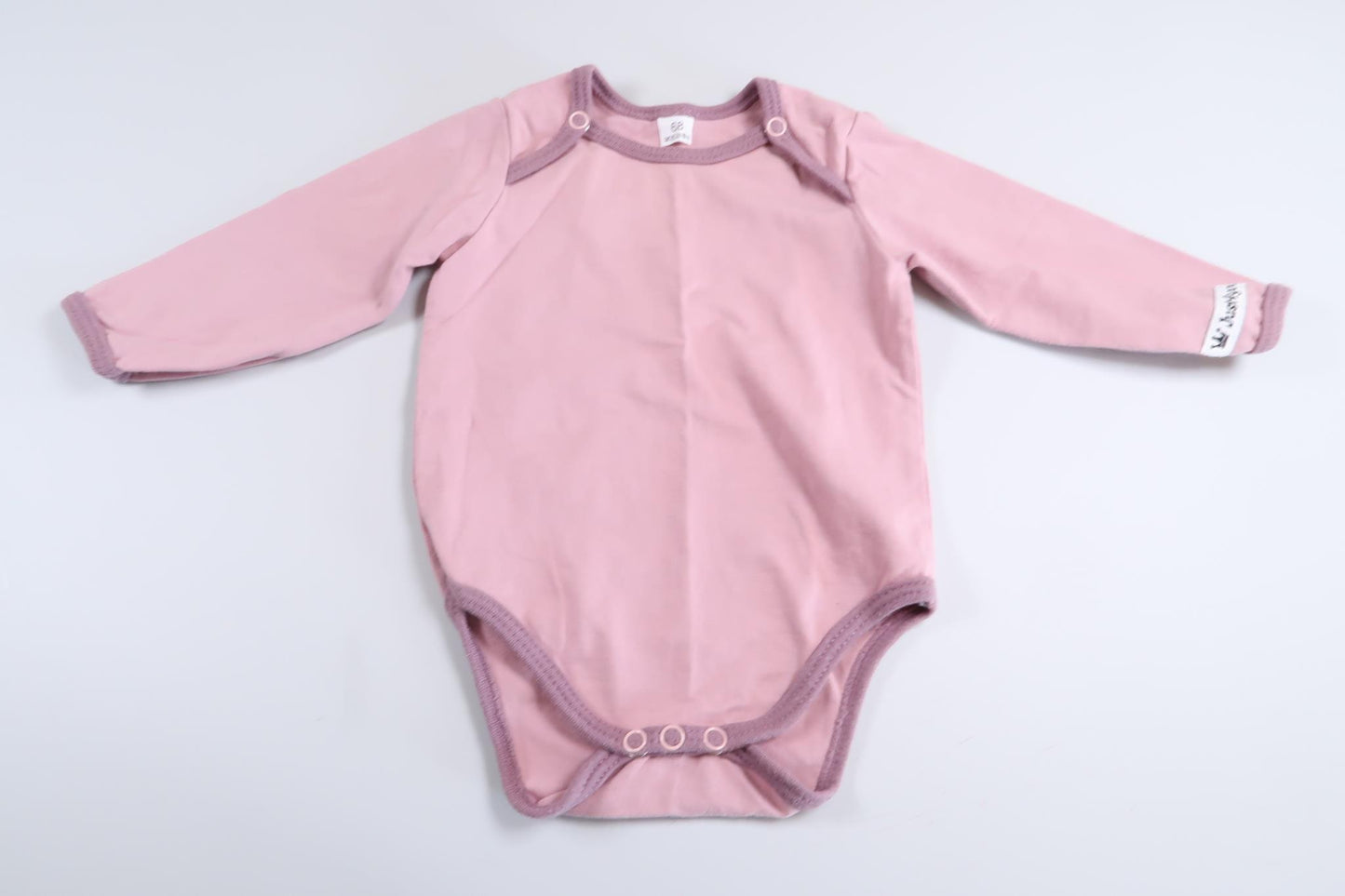 Rosa långärmad body i storlek 68