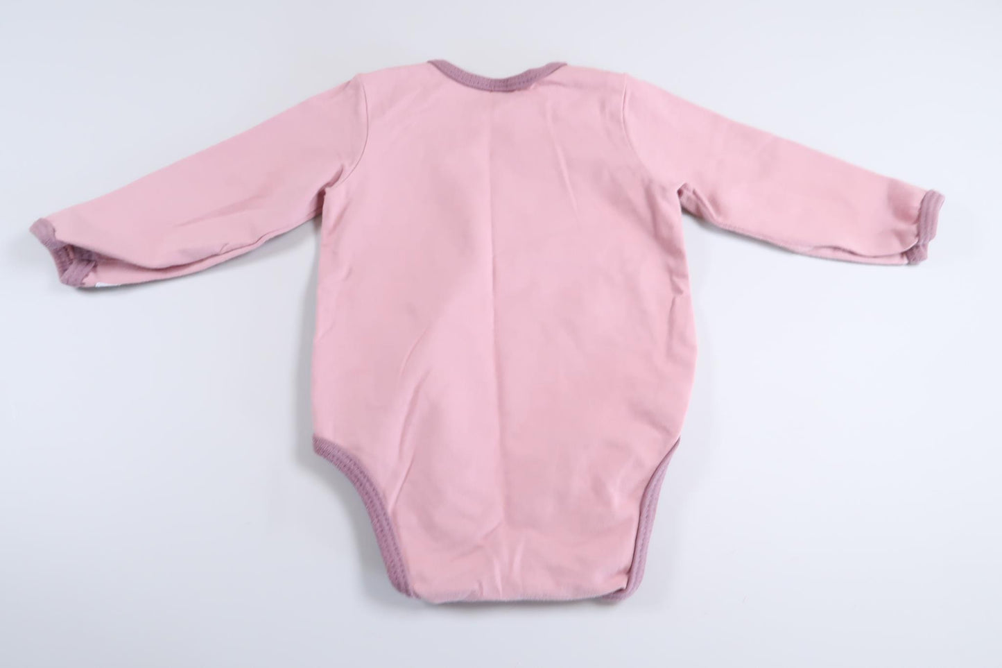 Rosa långärmad body i storlek 68