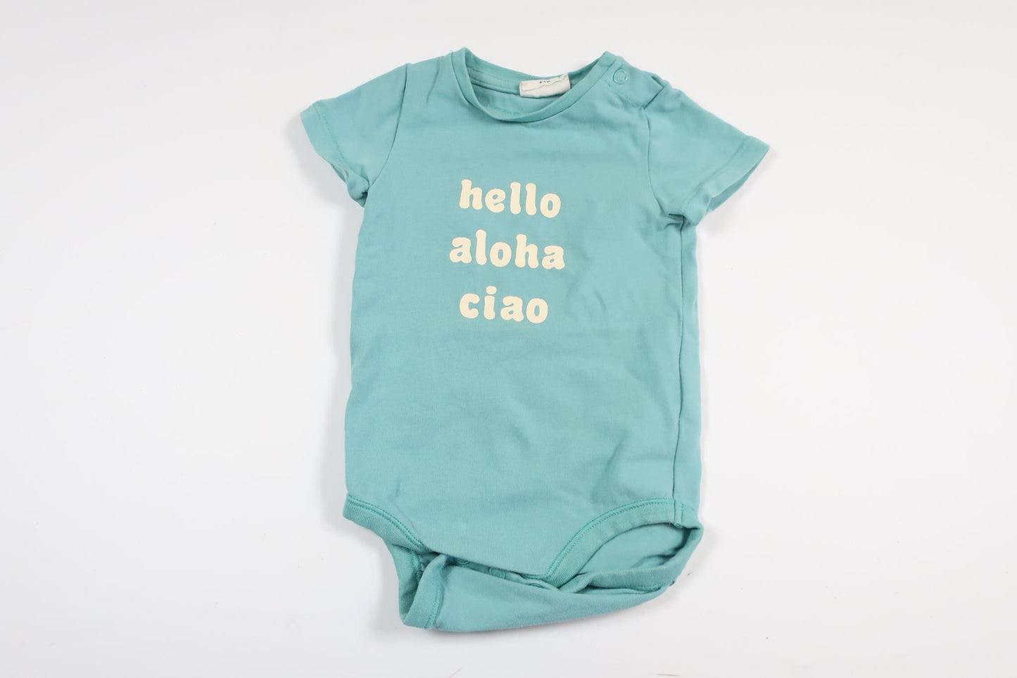 Ljusblå kortärmad body med text från Kappahl i storlek 62