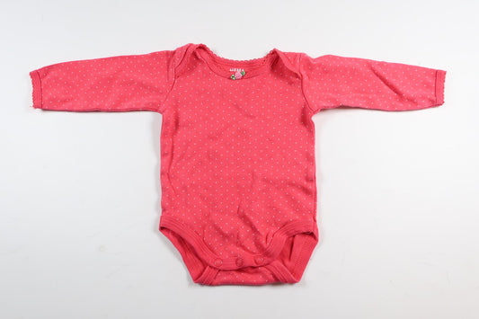 Neon rosa prickig långärmad body från HEMA i storlek 50/56