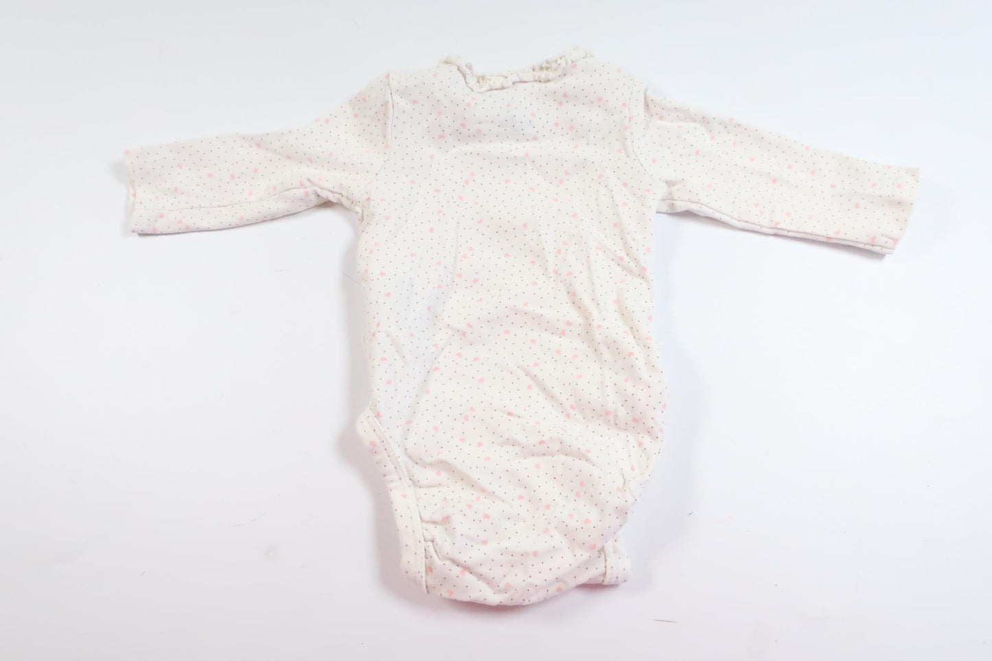 Vit långärmad body med hjärtan och prickar från H&M i storlek 50