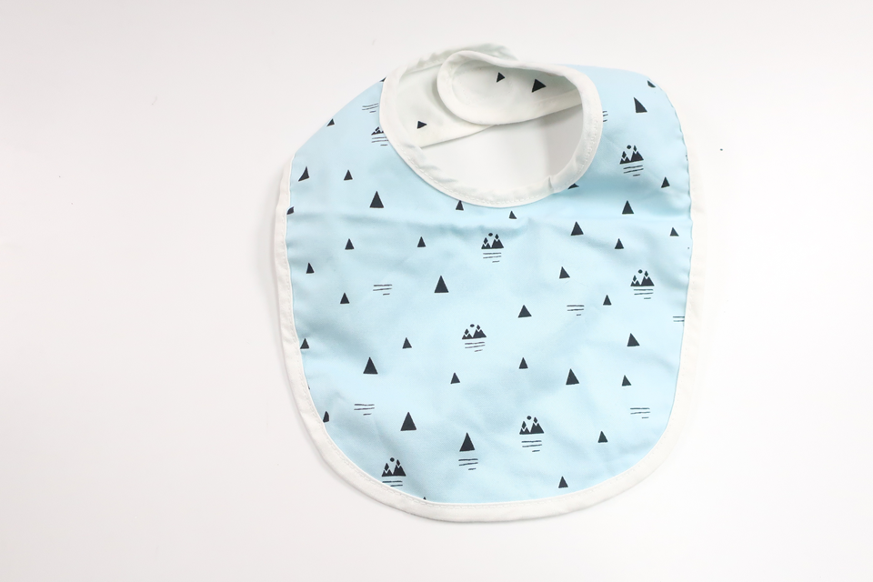 Vändbar haklapp från Stokke - Storlek One size - Blå